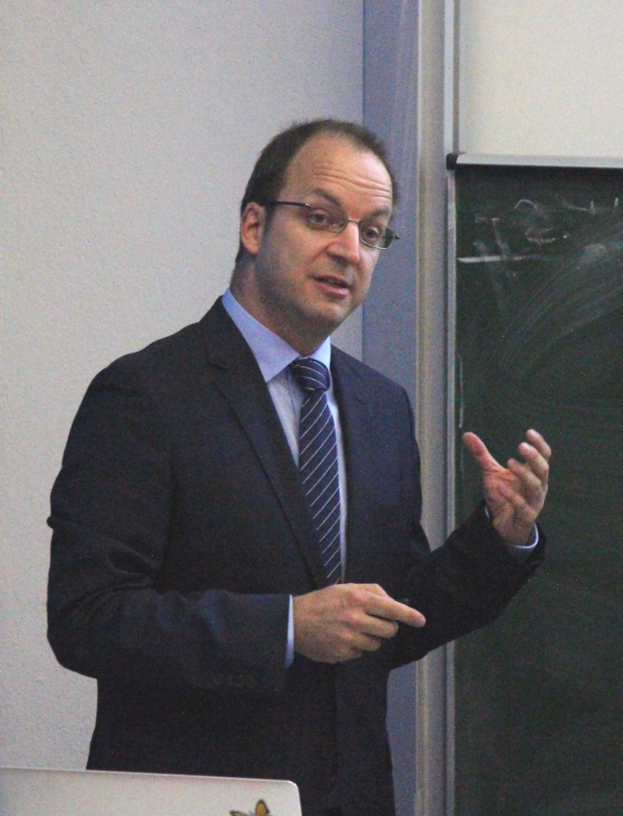 male teacher in front of blackboard
